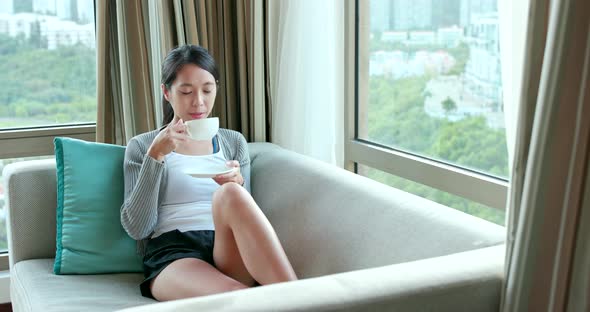 Woman watching the view out of window at home 