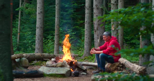 Bearded Male Tourist Near Campfire in the Forest