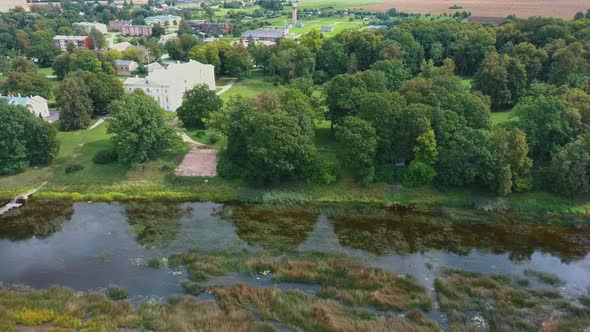 Aerial Shot City Mezotne, Latvia Republic. Mezotne Palace and Park With Fountain. Lielupe River With