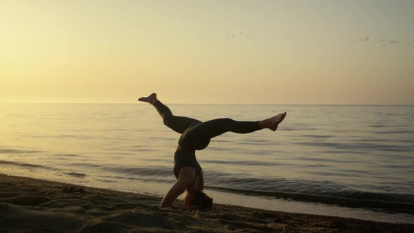 Slim Girl Keeping Balance in Headstanding Outdoors