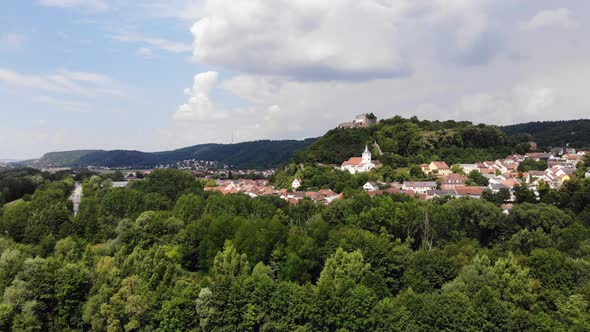 Aerial view of Donaustauf town and ancient castle on the hill, View from the Danube River, Zoom in
