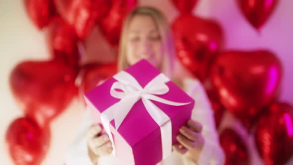 Excited Young Woman Customer Showing Bright Pink Magenta Gift Box White Ribbon