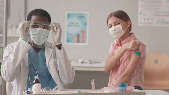 Portrait of Doctor with Schoolgirl after Vaccination