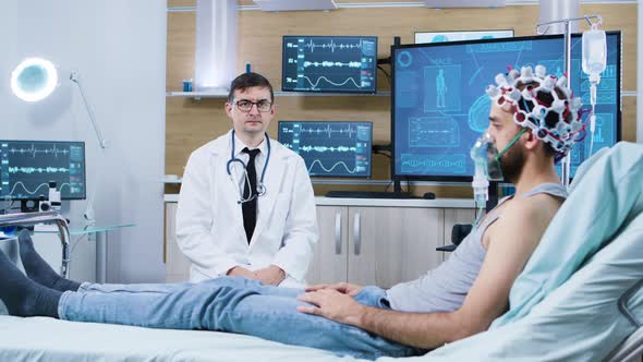 Doctor Sitting on Chair in Modern Brain Research Facility and Making Hand Gestures