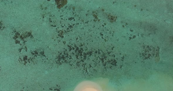 Aerial drone view of a scenic tropical island in the Maldives.