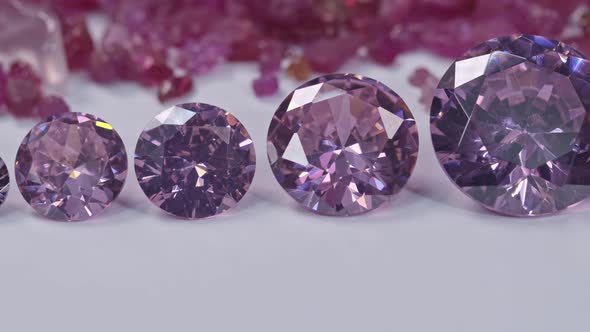 Amethyst Diamonds In A Row On White Flore Raw Ruby Gemstone Background.