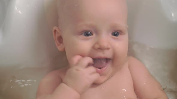 A Closeup of a Baby Girl Enjoying Bathing