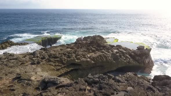 Marvelous aerial view flight drone shot. Big ocean waves crashing on the rocks of Devil's Tear at Le