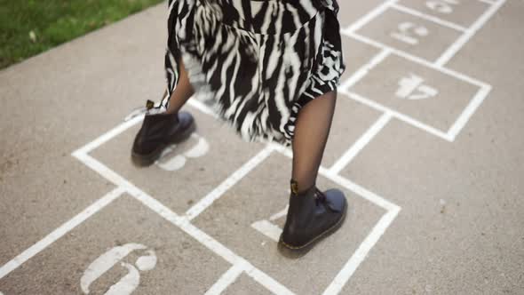 Woman playing hopscotch