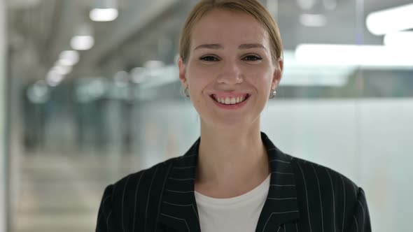 Portrait of Smiling Businesswoman Looking at Camera 