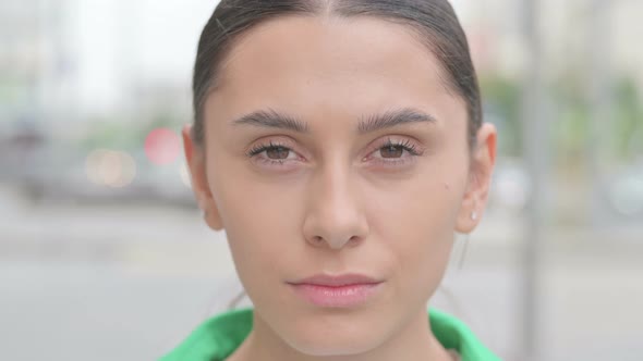 Close Up of Hispanic Woman Face Looking at the Camera Outdoor