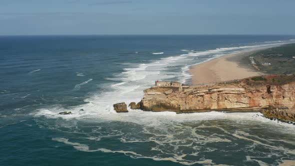 Aerial Footage of Coastal Area with Foamy Wave