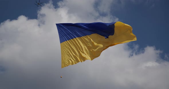 Ukraine Flag On A Background Of Blue Sky, Raised By A Drone In The Air, Develops In The Wind 