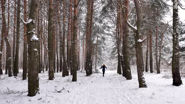 Girl enjoys in the winter snowy forest