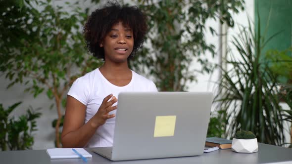 Confident Young AfricanAmerican Woman Talking and Gesturing During Online Remote Video Conference