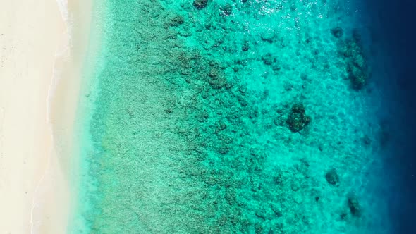 Aerial top view nature of tropical bay beach vacation by blue ocean with bright sand background of a