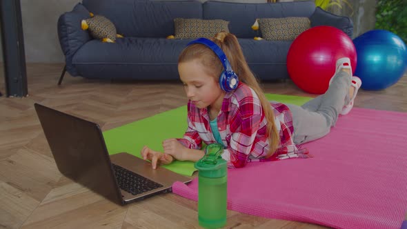 Relaxed Adorable Girl in Headphones Working on Laptop