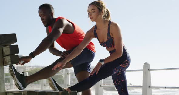 Couple exercising on a promenade at beach 