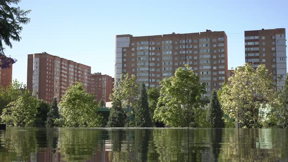 Beautiful Pond Park Green Trees and Highrise City Houses