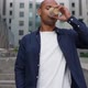 Confident Ethnic Pedestrian Drinking Hot Beverage and Using Smartphone - VideoHive Item for Sale