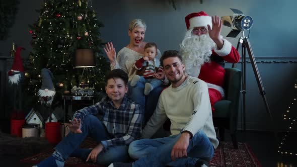 Family Together Santa Claus Sitting Sofa Floors Looking Camera