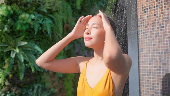 Young asian woman enjoy around outdoor swimming pool for leisure