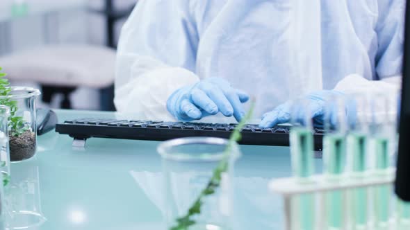 Close Up Shot of Scientist Typing on Computer Keyboard alt