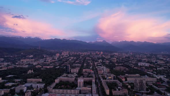 Pink and White Sunset and Clouds Over Mountains