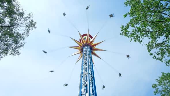 Amusement Park Visitors Ride High Colorful Sky Flyer