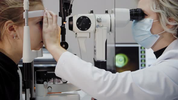 The Ophthalmologist Examines the Patient's Eye and Then Looks Into the Camera