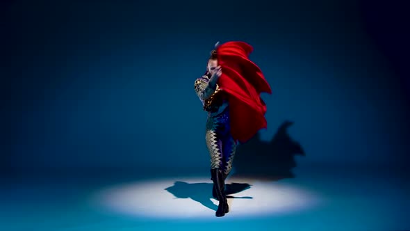 Torero in Blue and Gold Suit or Typical Spanish Bullfighter Isolated Spotlight on a Blue Background