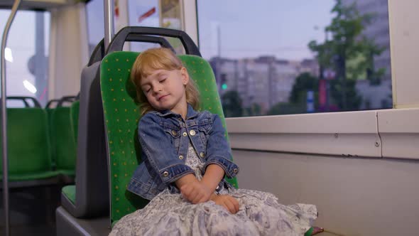 Tired Bored Little Child Girl Sitting Alone in Bus Transport After Hard Study Day and Falls Asleep