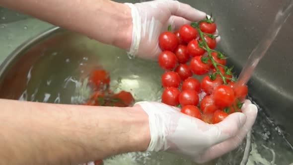Hands Washing Cherry Tomatoes