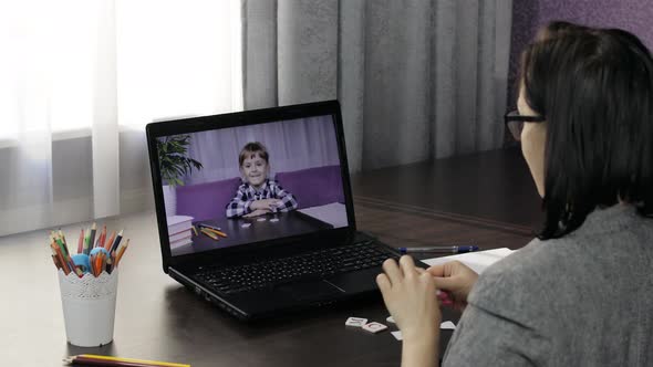 Woman Teacher Making Video Call on Laptop with Little Pupil. Distance Education