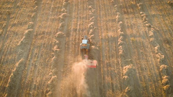 Aerial View of Tractor with Hay in the Field. Bales of Hay Stacked in the Trailer. Agricultural Work