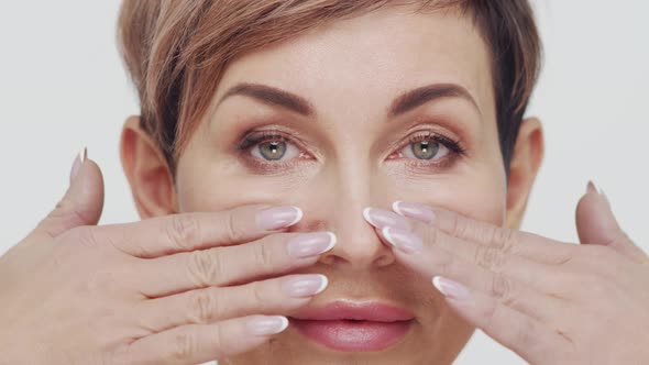 Close-up of middle aged mature woman over white background.