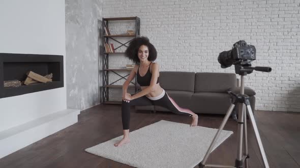 Online Yoga Coach. Young Smiling African Lady Vlogging and Leading the Youga Classes.
