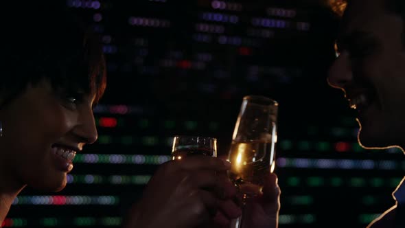 Couple toasting champagne in bar