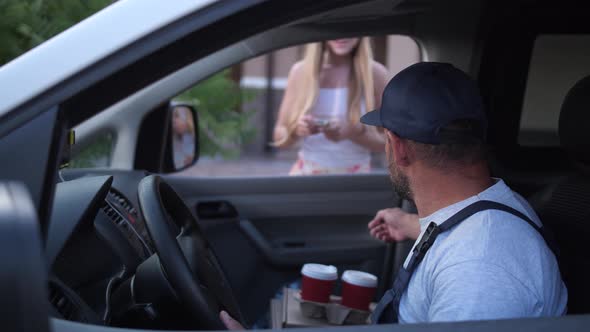 Female Client Taking Coffee From Delivery Man