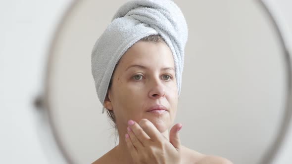 Female applying liquid powder foundation on face skin 4K 2160p 30fps UltraHD footage - Woman in fron