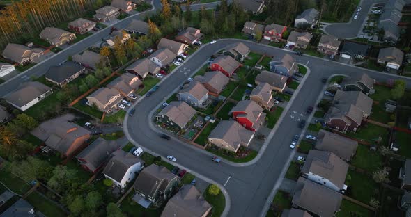 Orbiting aerial above a grouping of homes in an American neighborhood.