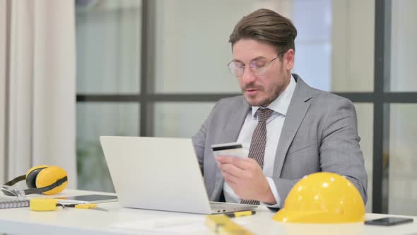 Middle Aged Engineer making Successful Online Payment on Laptop