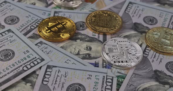 Close Up of Metal Shiny Bitcoin Crypto Currency Coins on US Dollar Bills