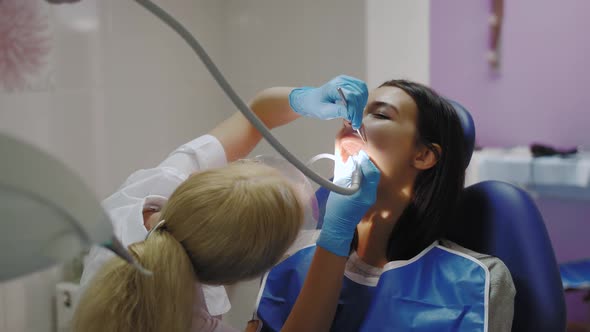 Dentist Doing a Dental Treatment on a Female Patient