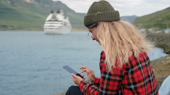 Young Woman Sits in Port Watch Cruise Ship Leave