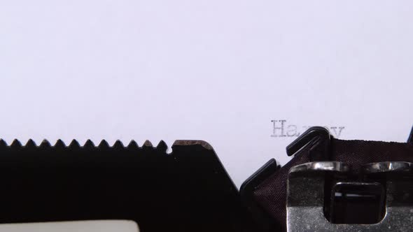 Man Is Typing a Letter on the Typewriter of a Happy New Year. Close Up