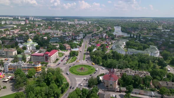 Aerial View of Roundabout Road with Circular Cars in Small European City at Sunny Day