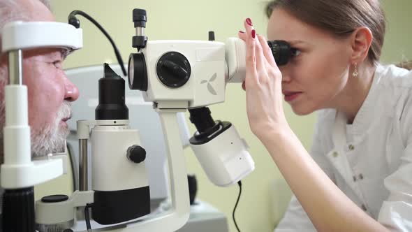 Ophthalmologist Examination of Elderly Man with Slit Lamp