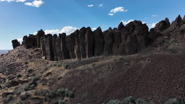 Rising aerial shot that crests over the top of the climbing rocks at Frenchman Coulee in Washington