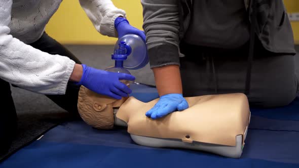 Training on a medical mannequin. People doing cardiopulmonary resuscitation.